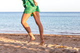 Leg of woman running on sand beach. summer vacation. Happy beautiful woman running on the beach