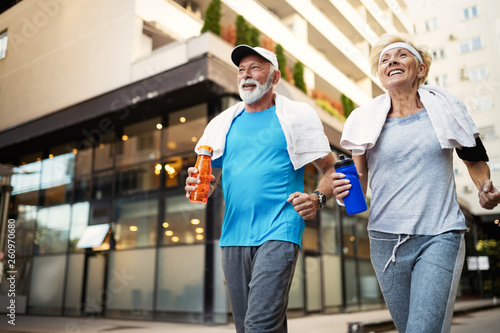 Happy senior people running to stay helathy and lose weight photo