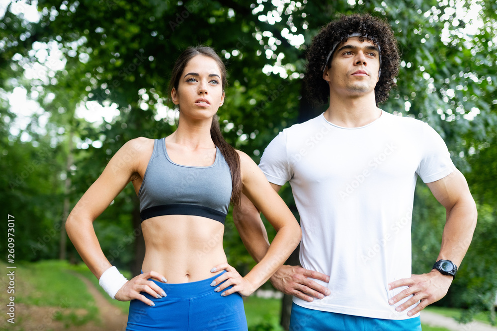 Fototapeta premium Happy young people jogging and exercising in nature