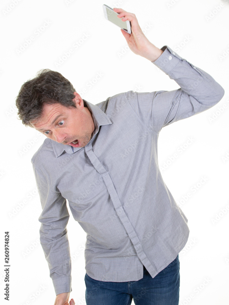 angry caucasian man frustrated and furious with his phone conflict with customer service over white background angry caucasian man frustrated and furious with his phone conflict with customer service over white background