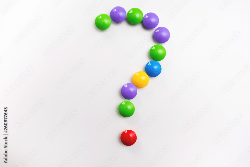 A question mark made from children's toys. Multicolored figures for games A question mark made from children's toys. Multicolored figures for games