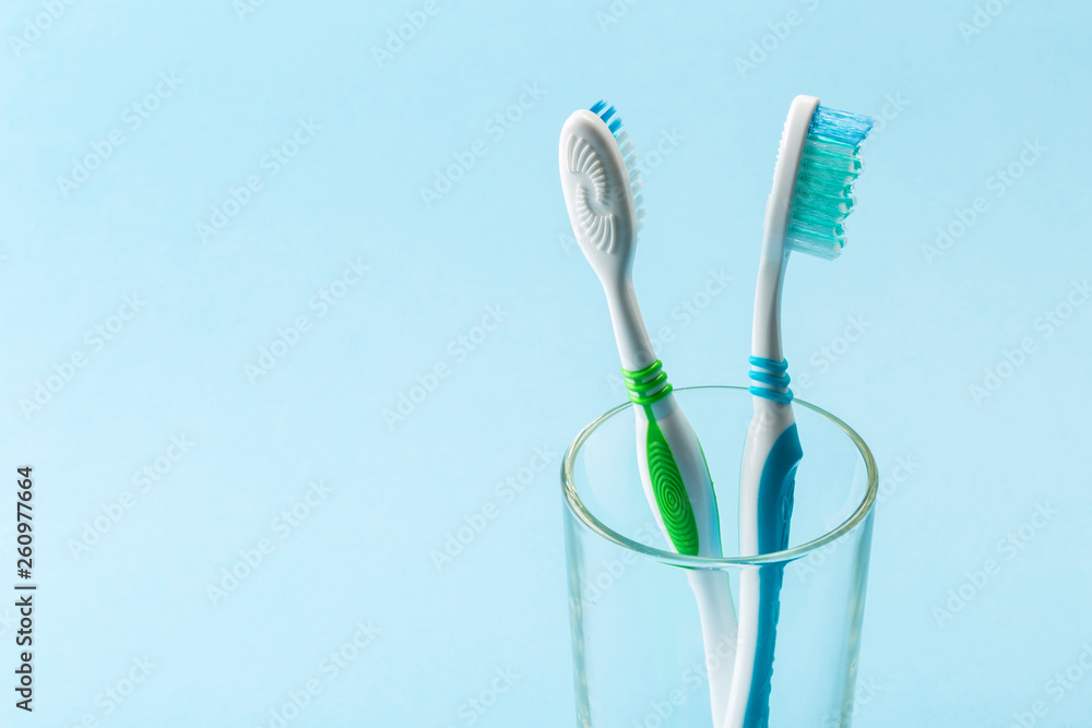 Set of toothbrushes in glass on blue background. Set of toothbrushes in glass on blue background.