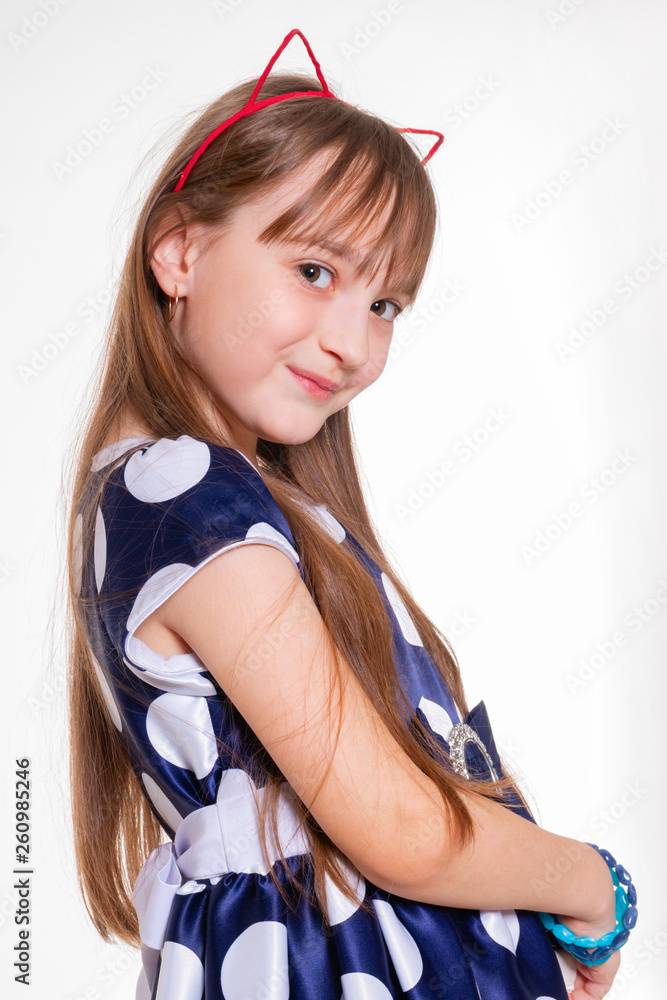 Portrait of a little cheerful girl with cat ears and in a polka dot dress Portrait of a little cheerful girl with cat ears and in a polka dot dress