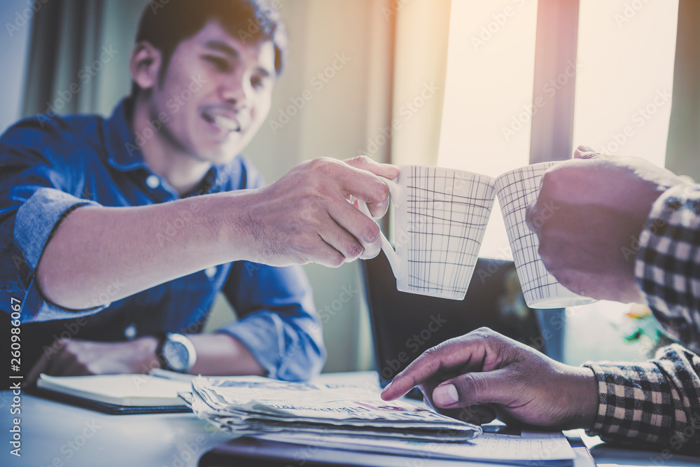 Φωτογραφία businessmen sitting at a desk,friends talking of their own fun,colleagues show m