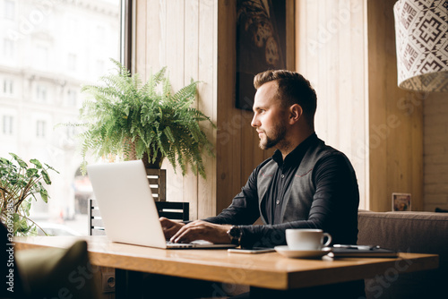 Young handsome businessman conducting negotiations with investors. Electronic business. Alternative payment services. Management of the projects on freelance. Cryptocurrency. Blockchain. Trader.