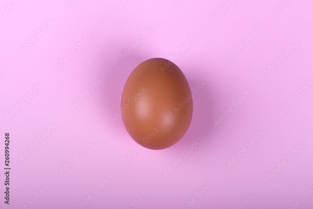 Single chicken egg on pink background Single chicken egg on pink background