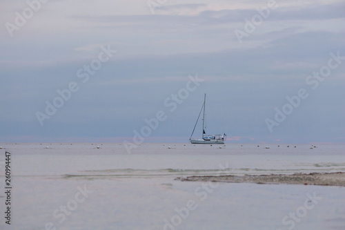 Sailing Boat Sailboat anchoring infront the white beach a Tranquil seascape scene with calm sea