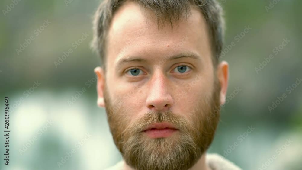 Portrait of beard man outdoors. Serious looking at the camera. Portrait of beard man outdoors. Serious looking at the camera.