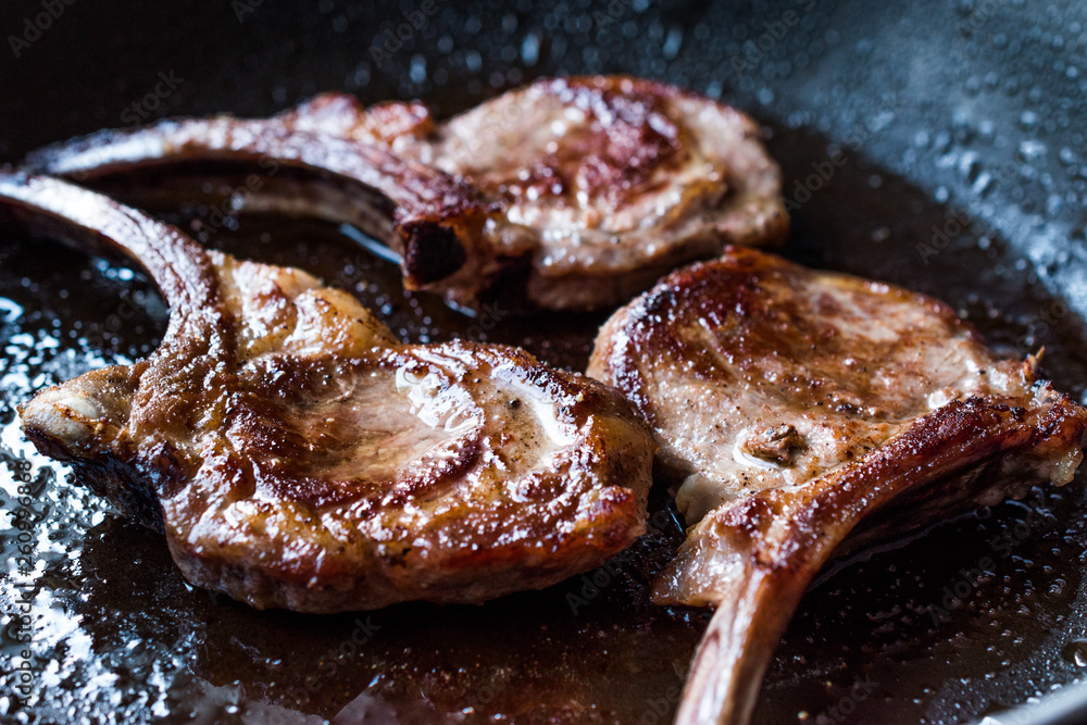 Fototapeta premium Fried Lamb Chops in Pan. Grilled and Sauteed
