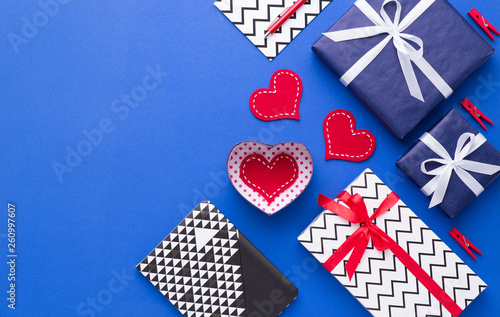 Person holding a present for Saint Valentine's day in his hands. Beautiful colorful background to st. Valentine day. Greeting card with red hearts. Wedding's invitation. Love expression. 