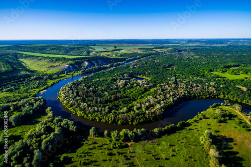 The river flows through the valley. Beautiful landscape. Aerial view. The bend of the river. Panorama. River landscape. Drone photography