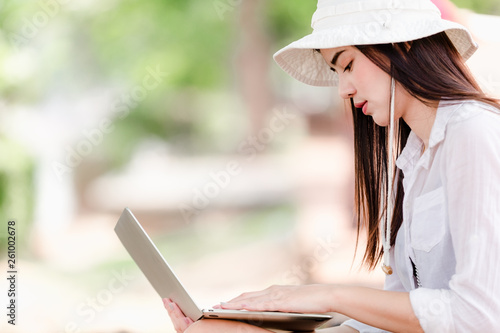 Asian young girls traveler in city,Women sitting use laptop search for attractions