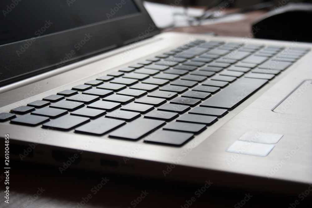 Photo of a laptop keyboard with selective focus on the keys and a soft and warm bokeh background Photo of a laptop keyboard with selective focus on the keys and a soft and warm bokeh background
