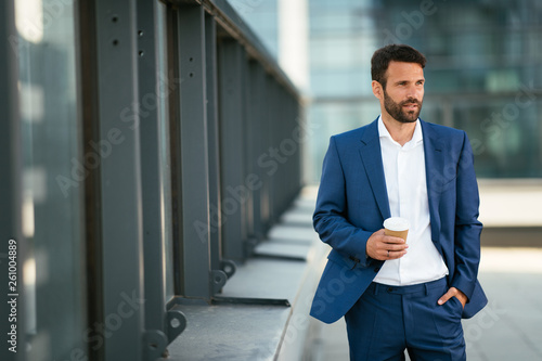 Businessman on a coffee break. Manager otuside drinking coffee. Lawyer having a break , drinks coffee to go. photo