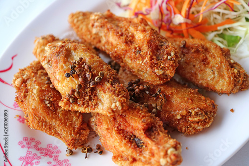 Plate of Northern Thai Deep Fried Chicken Wing with Hot and Spicy Herbs