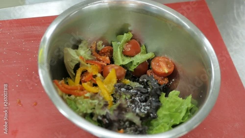 Chef praparing Greak salad in the restaurant kitchen photo