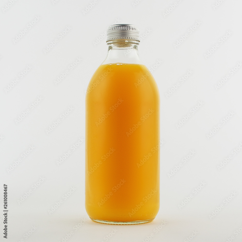 Glass bottle of fresh orange juice, isolated, white background Glass bottle of fresh orange juice, isolated, white background