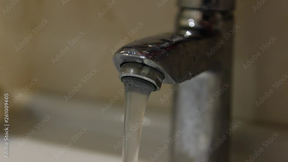 Turn on the tap. Water. Crane. Sanitary equipment. Bathroom. Close-up Turn on the tap. Water. Crane. Sanitary equipment. Bathroom. Close-up
