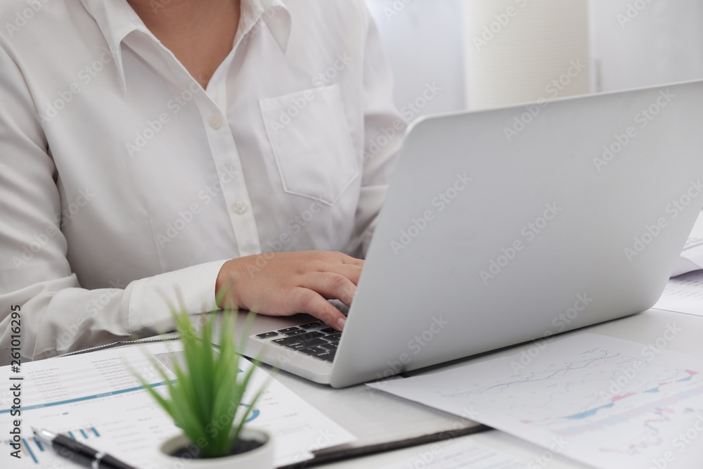 young female professional working in bright office . young female professional working in bright office .