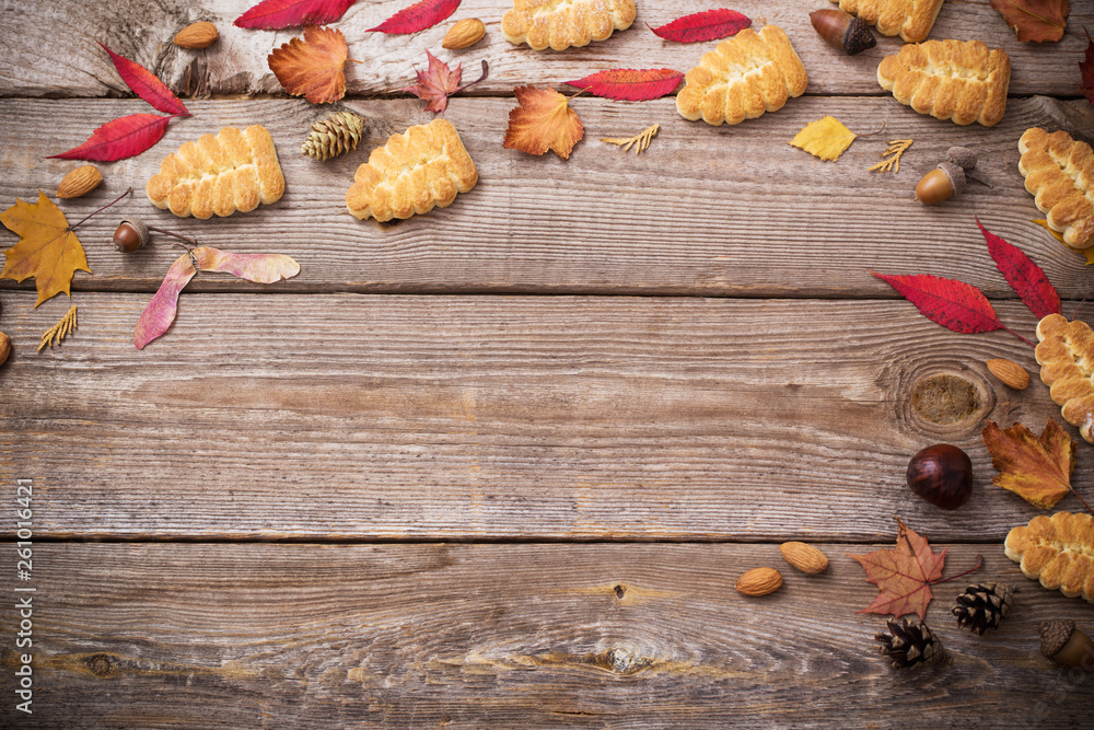 cookies and autumn leaves on wooden background cookies and autumn leaves on wooden background