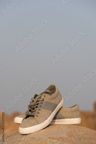 Stylish Men Olive Green Sneakers or Regular Shoes on top of the mountain. photo