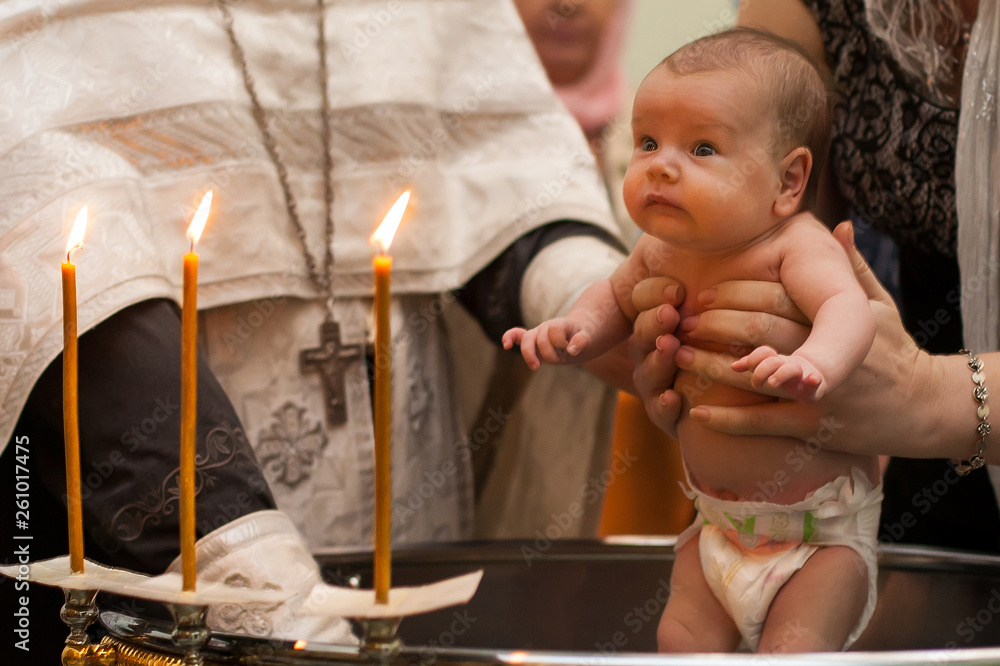 Newborn baby baptism in Holy water. baby holding mother's hands. Infant ...