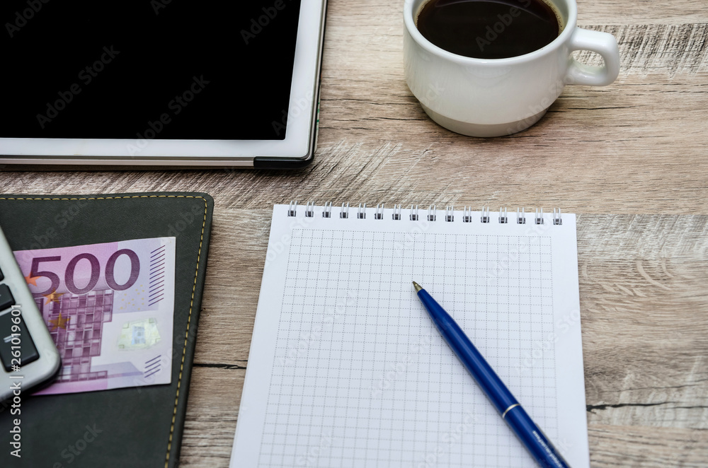 notebook, pen, cup of coffee and money on wooden background notebook, pen, cup of coffee and money on wooden background