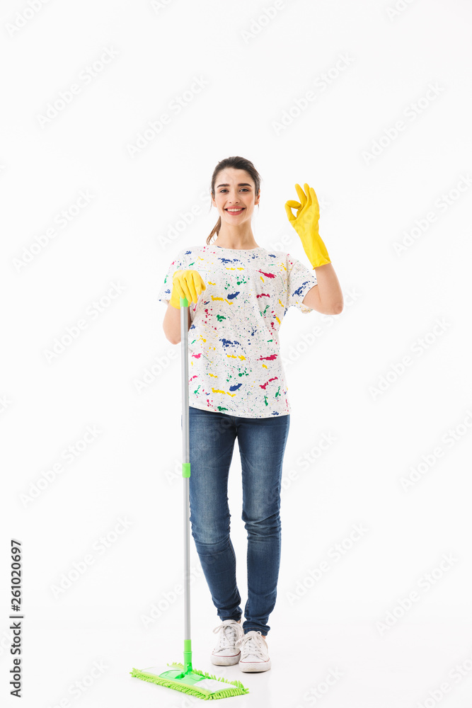 Full length photo of caucasian housewife 20s wearing yellow rubber gloves washing the floor with mop Full length photo of caucasian housewife 20s wearing yellow rubber gloves washing the floor with mop