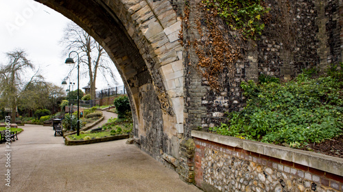 A view through the stone archway towards Castle Meadow Gardens in the city of Norwich  Norfolk