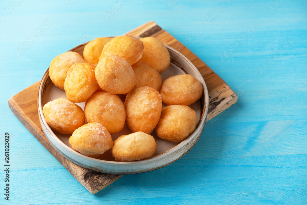 Baursak - traditional Kazakh (Asia) food \ national bread in plate on blue wooden background, top view