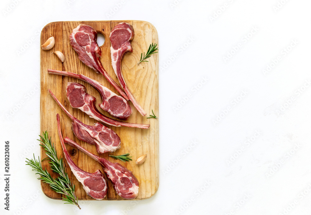 Raw cut lamb chops lying on a cutting board Raw cut lamb chops lying on a cutting board
