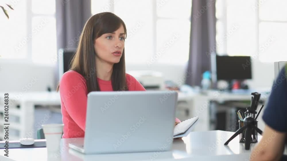 Young businesswoman sitting at modern office and using technology. Young businesswoman sitting at modern office and using technology.