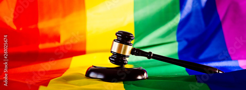 Woden judge mallet symbol of law and justice with lgbt flag photo