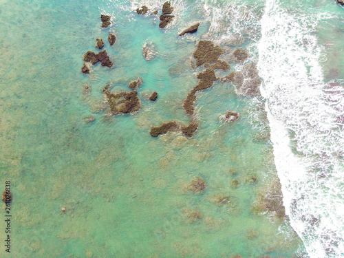 Aerial view of sandy beach with tourists swimming in beautiful clear sea water - Taiwan North Coast , shot in Sanzhi District, New Taipei, Taiwan