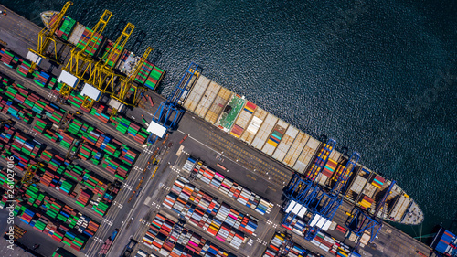Aerial top view container cargo ship unloading in import export business logistic and transportation of international by container cargo ship in the open sea.