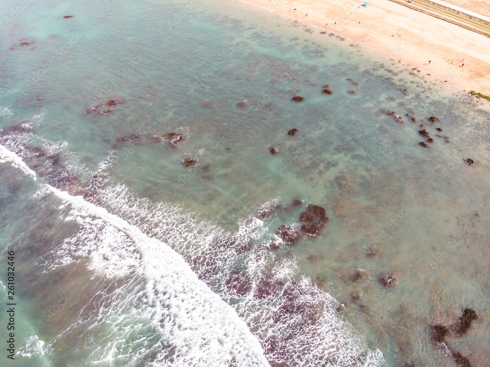 Aerial view of sandy beach with tourists swimming in beautiful clear sea water - Taiwan North Coast , shot in Sanzhi District, New Taipei, Taiwan