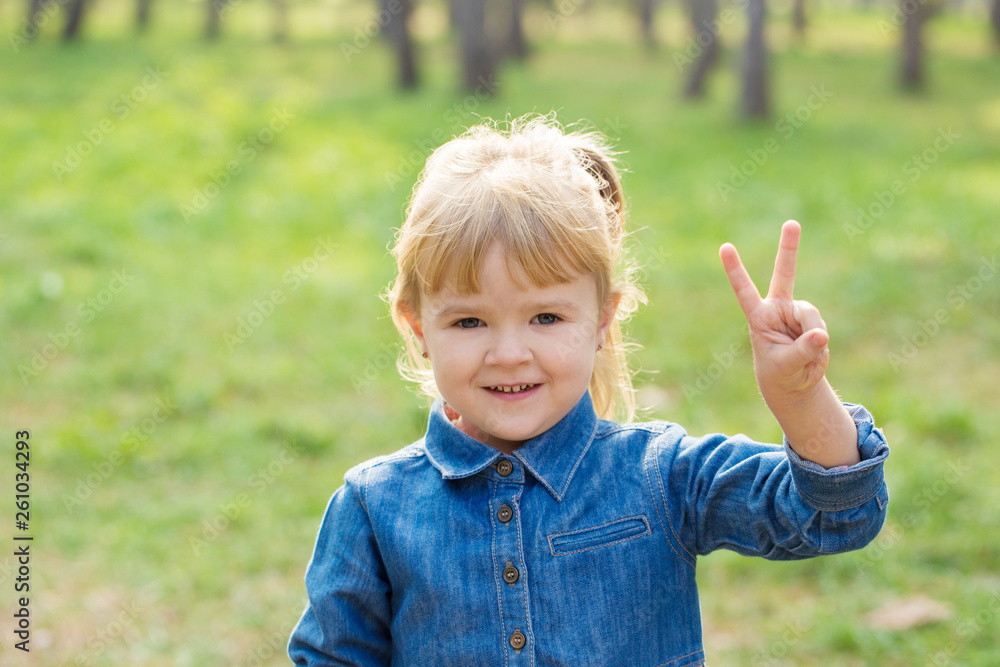 portrait of happy little girl with smile on face on sunny day portrait of happy little girl with smile on face on sunny day