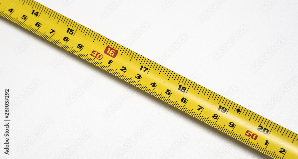 Yellow Measuring Tape Curls On A White Background Isolated Stock