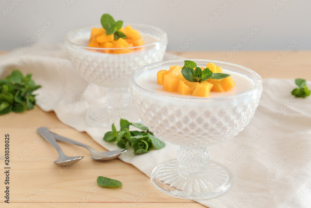 Bowls of delicious panna cotta on wooden table Bowls of delicious panna cotta on wooden table