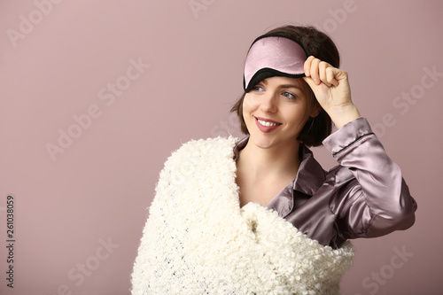 Young woman with sleep mask...