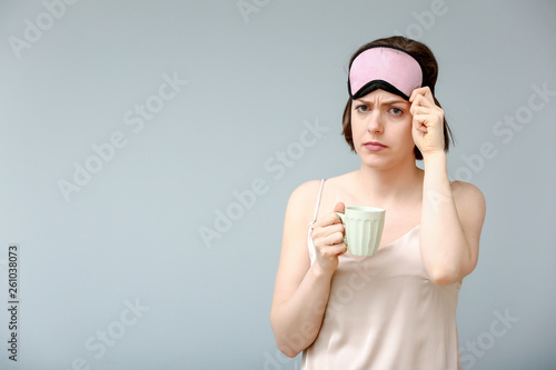 Sad woman with sleep mask a...