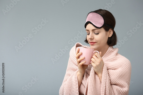 Young woman with sleep mask...