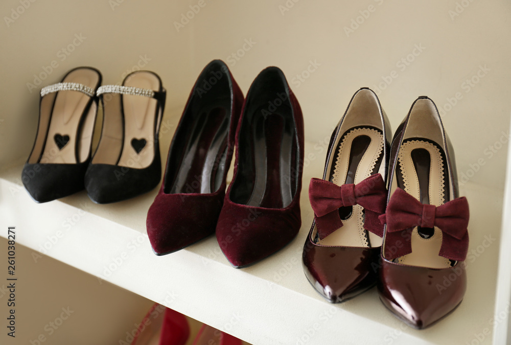 Collection of new female shoes on shelf in shop