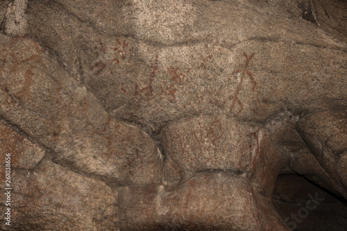 Ancient images of people on the wall of the cave history of antiquities, archeology.