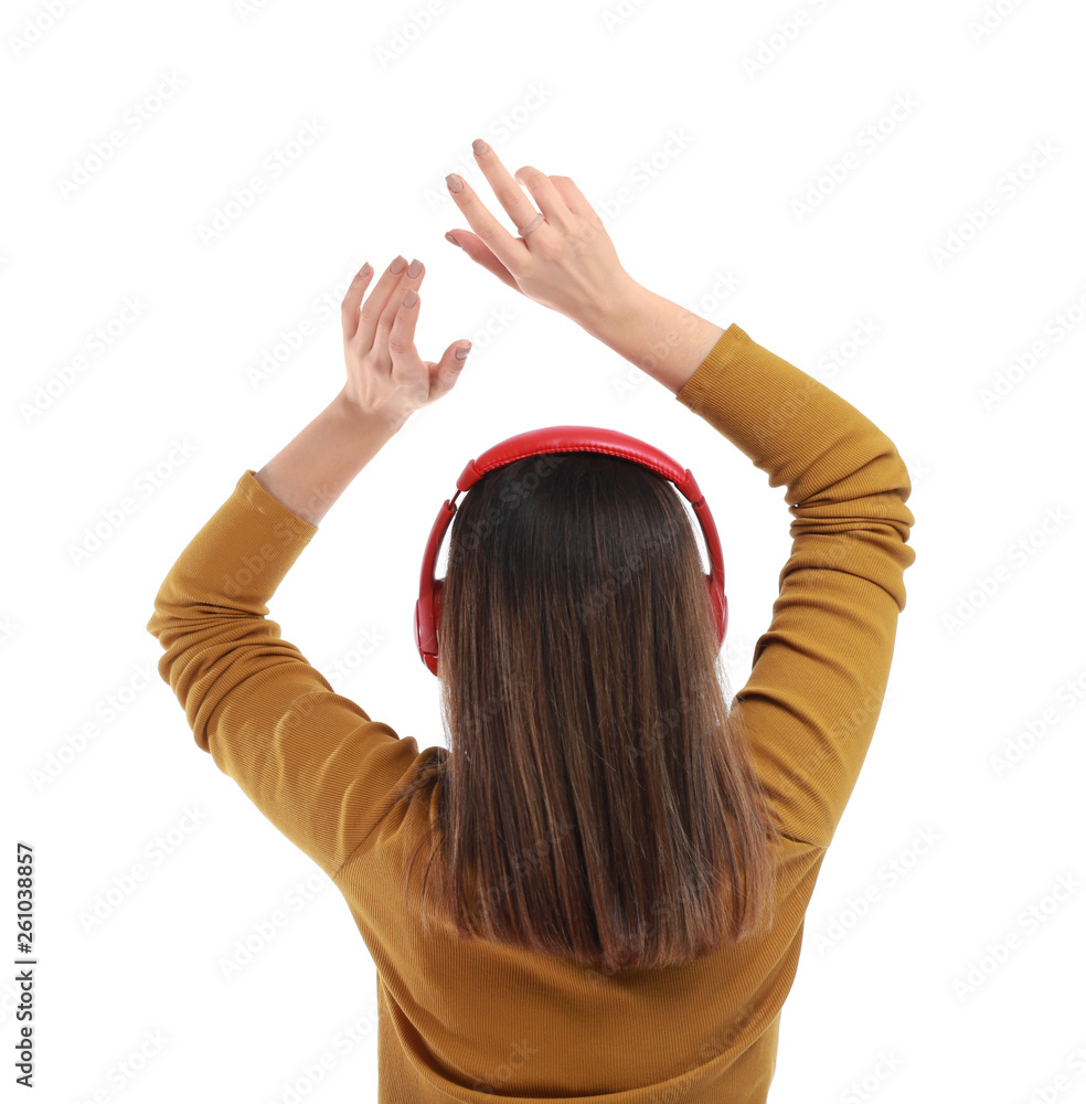 Naklejka premium Young woman with headphones listening to music on white background