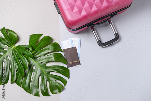 Suitcase, tropical leaves a...