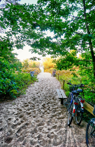 Fototapeta Naklejka Na Ścianę i Meble -  Bicycles on the sandy path to the beach to the Baltic Sea. Zinnowitz on the island of Usedom.