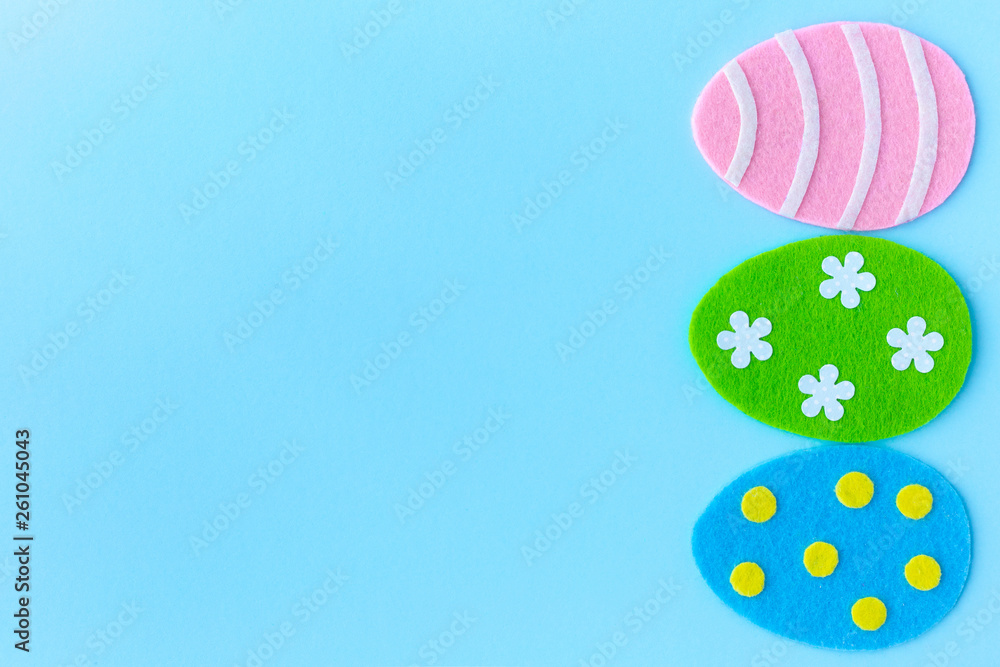 Beautiful cute easter holiday frame of handmade craft colorful eggs and blue copy space. Top view flat lay color photography.