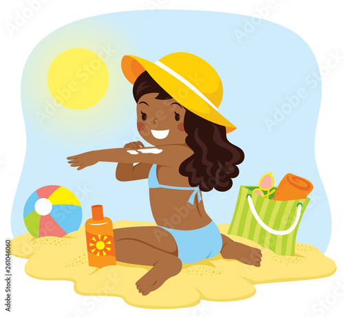 Cute dark skinned girl applying sunscreen at the beach