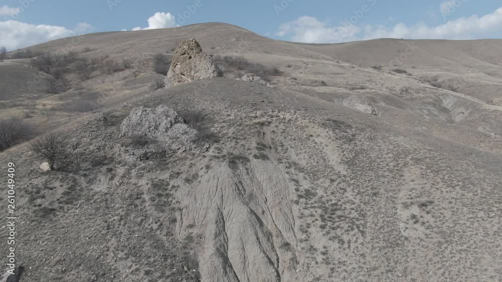 drone flight over a hillside with sparse vegetation in autumn on a sunny day drone flight over a hillside with sparse vegetation in autumn on a sunny day